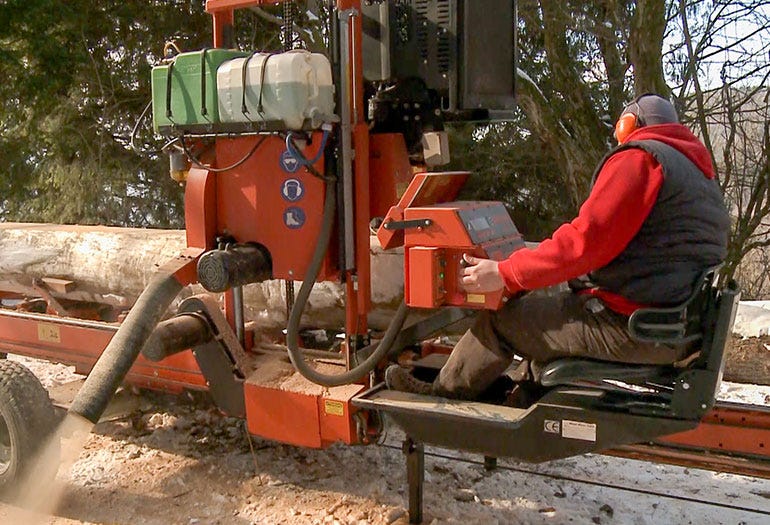 Operator sits in a comfortable chair while sawing
